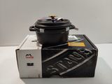 a black pot sitting on top of a box on a table