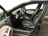 the interior of a car with the door open and the driver ' s seat down