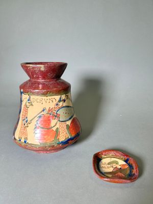 a small vase and a small bowl on a table
