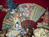 a doll sitting on top of a table next to a fan
