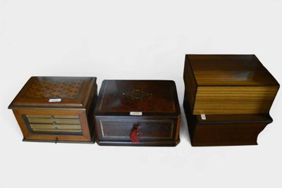 three small wooden boxes are lined up next to each other