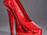 a red high heeled shoe on a grey background