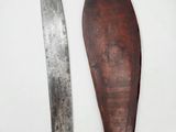 pair of old wooden knives on a white surface with a white background