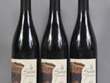 three bottles of wine sitting on top of a table next to each other