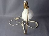 a lamp that is on a stand with a pen on it