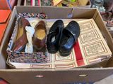 two pairs of shoes in a box on the floor