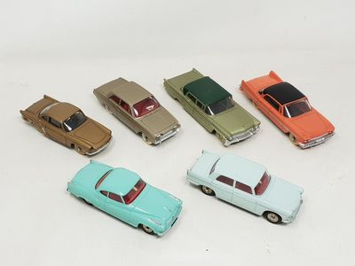 several toy cars are lined up in a row on a white surface