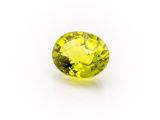 a yellow sapphire stone on a white background