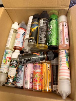 a cardboard box filled with assorted crafting supplies