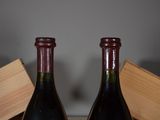 two bottles of wine sitting next to each other on a table