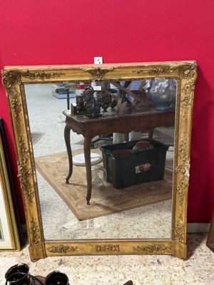 a mirror and a pair of shoes on the floor