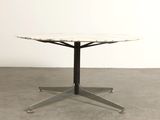 an image of a white marble table with a black metal base