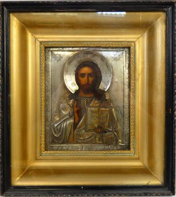 une vieille image de Jésus tenant un livre, dans un cadre doré