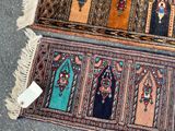 two rugs on the floor with a tag on them