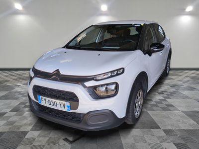 the white citrole is parked on a checkered floor in a garage