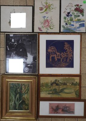 many framed pictures hanging on the wall of a room