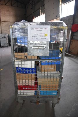 a metal cart with boxes on it in a warehouse