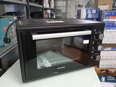 a black toaster oven sitting on a counter in a store