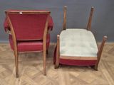 pair of red chairs and a foot stool on a parquet floor