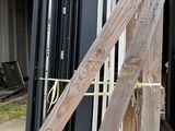 several pieces of wood are stacked on top of each other in front of a building