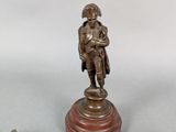 pair of antique bronze figurines of a soldier on a pedestal