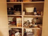 a pantry with a lot of dishes and dishes on the shelves