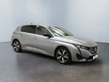 a silver car is parked in a room with a white wall