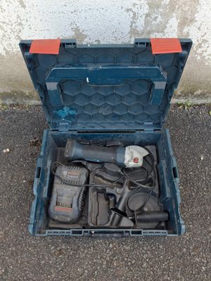 a blue tool box with tools in it on the ground