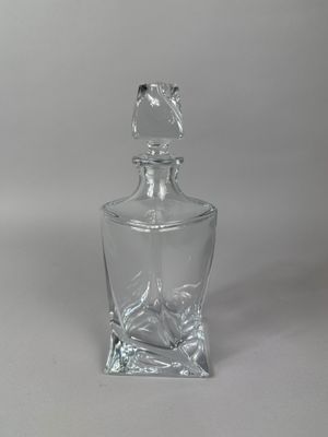 clear glass decanter with a bird on the top of it