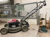 a lawn mower that is parked in a garage