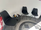 three black chairs in the corner of a room