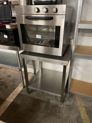 an oven that is sitting on a stand in a room