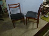 two chairs sitting next to each other in a room