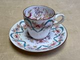 a cup and saucer sitting on a table