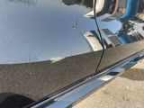 a reflection of a building on the side of a car