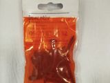 a small bag of orange plastic toys on a white surface