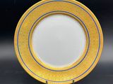 a close up of a yellow and blue plate on a black surface