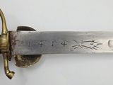 a close up of a sword with writing on it