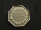 a close up of a coin on a black surface with a black background