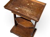 an old wooden side table with a drawer underneath it