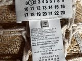 someone is holding a ball of yarn with a price tag on it