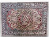 a close up of a rug with a floral design on it