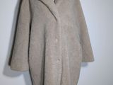 an image of a woman ' s coat on a mannequin stand