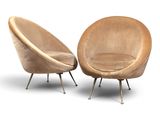 pair of mid - century modern lounge chairs with upholstered cushions and metal legs