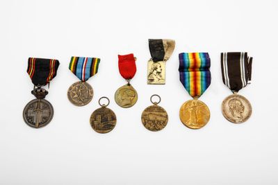 an assortment of medals and medals are displayed on a white surface
