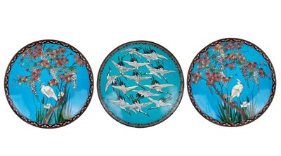 three plates with birds and flowers painted on them on a white background