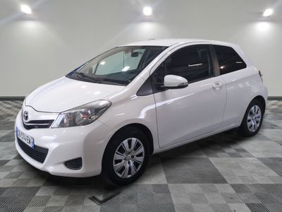 a picture of a white toyota yaris parked on a checkered floor