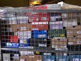 a metal cage filled with boxes and boxes on top of it