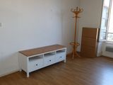 an empty room with a wooden floor and a white cabinet