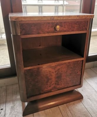 a wooden shelf with a drawer on top of it